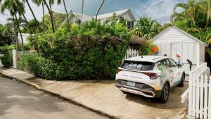 a car parked in front of a white fence at Casa Serendipity by Last Key Realty in Key West
