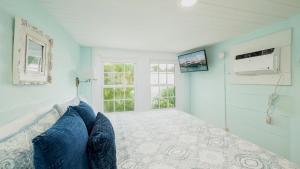 a bedroom with a bed and a window at Casa Serendipity by Last Key Realty in Key West