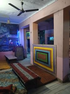 a living room with a couch and a tv at HOSTEL MONALISA PUSHKAR in Pushkar