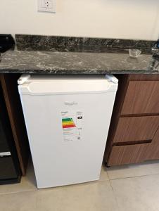 a white refrigerator under a counter in a kitchen at Tigre-Estación Fluvial Monoambiente in Tigre +14 photos