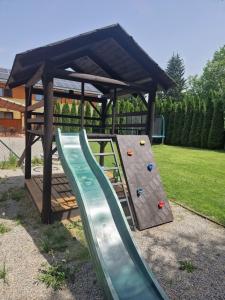 a playground with a slide and a gazebo at Apartmán Sophia 6 in Velké Losiny