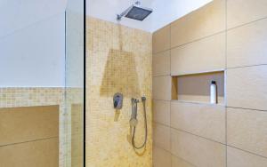 a shower with a shower head in a bathroom at Luxury 3 bedroom beach front apartment in Mombasa +12 photos