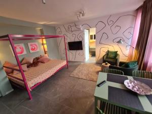 a bedroom with a pink bunk bed in a room at Be Magenta, Art Home - Rose style - Near Milano, Rho Fiera, Malpensa in Magenta