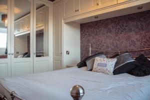 Un dormitorio con una cama grande con cabecero de madera. en Spacious 5-Bed Detached Home in Charming Tadcaster, en Tadcaster