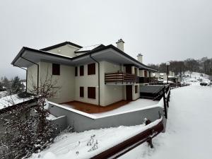 a house is covered in snow with a yard at Campaegli House in Campaegli