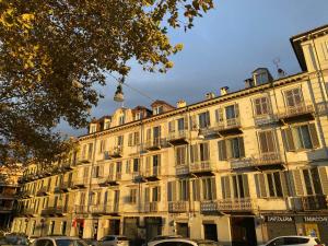 a large building with cars parked in front of it at Casa Nina in Turin
