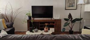 a living room with a couch and a flat screen tv at Casa Central in Socorro +21 photos