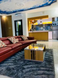 a living room with a couch and a coffee table at VILLA Emiliana SABADELL in Yaoundé