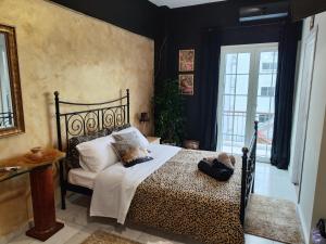 a bedroom with a black and white bed and a window at Anatolia in Veria