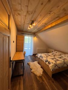 a bedroom with a bed and a wooden ceiling at Julia Vendeghaz Fony in Fony