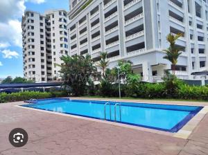 a swimming pool in front of a large building at Noble Villa Condo Georgetown City Center Macalister 3 Bedroom 3 Carpark in George Town