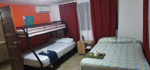Postel nebo postele na pokoji v ubytování Cuartos independientes con baño privado - Casa La Dolce Vita Las Tablas