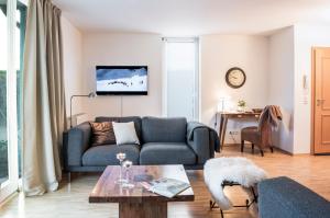 a living room with a couch and a table at Parkside Apartment House in Düsseldorf