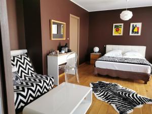a bedroom with a bed and a desk and a chair at U Muzzelo in Oletta +49 photos