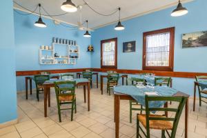 comedor con mesas y sillas y paredes azules en Il Lato Azzurro, en Venecia
