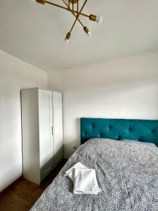 a bedroom with a blue headboard and a white cabinet at Luxury apartment Ema in Donje Mladice +24 photos