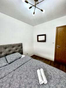 a bedroom with a bed with two white towels on it at Luxury apartment Ema in Donje Mladice