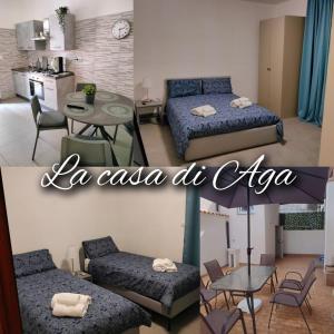 La casa di Aga في كاتانيا: غرفة بسريرين وطاولة ومطبخ