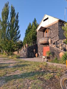 a stone house with a staircase leading up to it at Luiza Guest House in Areni