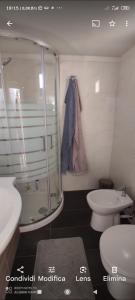 a bathroom with a shower and a toilet and a sink at Il giardino del Sole in Galatone +35 photos