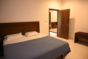 a bedroom with a bed and a door to a hallway at Nadackal Nature County in Munnar