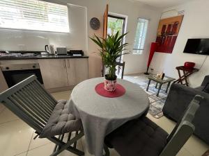 a living room with a table with a plant on it at A cozy cottage in Bryanston in Sandton +1 photo
