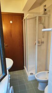 a bathroom with a shower and a toilet and a sink at Villetta Le Rocche - Rocca di Cambio in Rocca di Cambio +10 photos