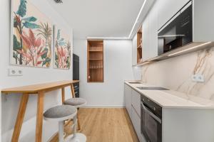 a kitchen with a table and two stools at Palacio Sempere in Alicante