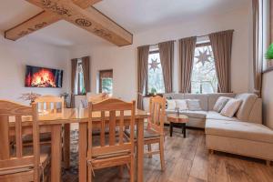 a living room with a table and a couch at Goralove Pole in Brzegi