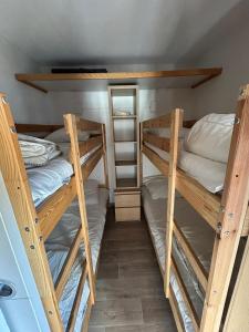 a room with two bunk beds and a mirror at Altineige 210 in Val Thorens