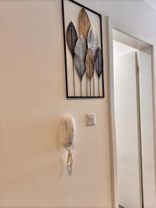 a phone is hanging on a wall with butterflies at Deluxe Loxwood Studio in Accra +32 photos