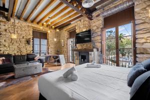 a bedroom with a large bed and a stone wall at Palacio Sempere in Alicante