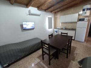 a kitchen and dining room with a table and a couch at Cabañas Jugueze San Rafael in San Rafael