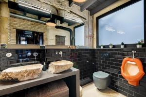 a bathroom with two sinks and an orange urinal at Palacio Sempere in Alicante +21 photos