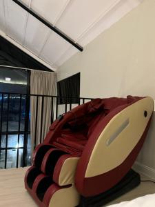 a bedroom with a large bed with a red and black comforter at غصن الهدا in Al Hada