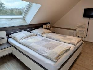 a bed in a room with a window at Ferienwohnung Martin Wadgassen in Wadgassen
