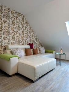 a white couch with pillows in a living room at Ferienwohnung Martin Wadgassen in Wadgassen