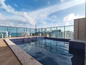 a swimming pool on the roof of a building at Gales de Pajuçara 703 Conforto, Piscina na Cobertura, Wifi 350 Mbps e a 50m da Praia! in Maceió