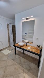 a bathroom with a sink and a mirror at DreamPlace Airport & Therme 3 in Otopeni