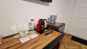 a kitchen counter with a red appliance on a table at DreamPlace Airport & Therme 3 in Otopeni