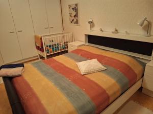 a bedroom with a large bed with a crib at Sunin Tupa in Rantsila