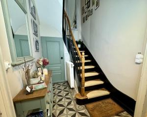 a hallway with a spiral staircase with a floor at Entre Terre et Estuaire & Spa in La Rivière Saint Sauveur +31 photos