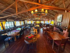 an overhead view of a restaurant with wooden tables and chairs at La Posta del Mistol in Las Tapias