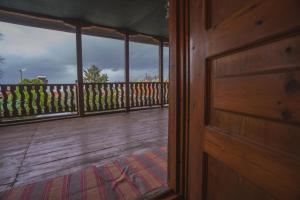 a door to a porch with a view of a deck at Secret garden Guest house Pozar Aridea in Aridaia