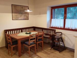 a dining room with a wooden table and chairs at Rozália Vendégház in Pázmánd