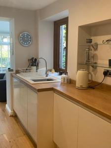 a kitchen with a sink and a counter top at Shore Cottage A traditional cosy cottage in Wilpshire