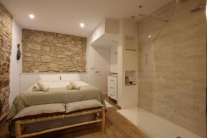 a bedroom with a bed and a walk in shower at Old Side Girona One in Girona