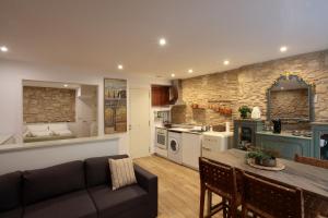 a kitchen and living room with a couch and a table at Old Side Girona One in Girona