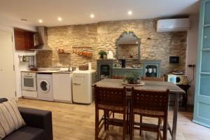 a kitchen with a table and chairs in a room at Old Side Girona One in Girona