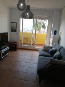 a living room with a couch and a tv at Lomas del mar V in Vera